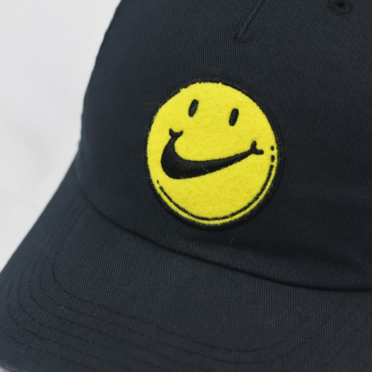 Nike Heritage86 Graphic Thrifted Cap - Black with Yellow Smiley Face Logo